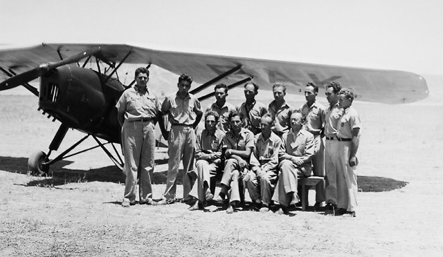 Aviators of the Aviron flying school, secretly run by the Jewish Haganah defense forces, near Afiqim, Jordan Valley, at pilot graduation ceremony on 20 July 1939, with a Polish RWD 8 (VQ-PAK). Sitting (left to right) are Israeli aviation pioneers Yitzhak Ben Yaacov (head of Aviron), Immanuel Zur (chief instructor of Aviron, and head of Lod Airport in December 1948), Emil Pohorilla (head engineer and maintenance manager) and Dov Hoz (a leader of Aviron, in charge of operations to help Jewish security). Yitzhak Ben Yaacov and Dov Hoz were killed in an auto accident in 1940. Today the airport at Rosh Pina, Israel, is named after Ben Yaacov, and the airport in north Tel Aviv is named after Dov Hoz. Standing, second and fourth from right, are Uri Breier and Yitzchak Hennenson who later became two of EL AL's original pilots. (Israel Government Press Office) 