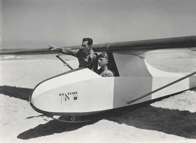 Benjamin Kahane (pointing) of the Aero Club of Israel, later a hero aviator in Israel’s 1956 Sinai Campaign, and Yitzhak Hennenson (seated), who became a captain with El Al, with a Grunau Baby before takeoff on the beach at Bat Yam, Palestine, in June 1939. On the nose of the glider appears the name 'Sion' (meaning ‘highest point’ or ‘record’) in Hebrew. (Israel Government Press Office) 