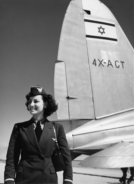 Tova Mizrachi, wearing the original EL AL flying star insignia of metal, was the EL AL/Arkia stewardess on the first flight to Eilat on 28 February 1950. The pictured C-46 was originally one of the Panamanian-registered LAPSA aircraft ferried out of the US via Panama to Israel, as can be seen by the obliterated Panamanian flag on the tail under the Israeli 4X-ACT registration. (Israel Government Press Office) 