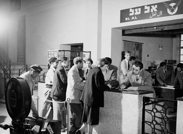 EL AL's first passenger check-in counter at Lod Airport in March 1951. Baggage was then weighed by hand. Shown writing at the counter is Zvi Blumenfeld, traffic agent and assistant to EL AL station manager Francie Oberlander. In the right background are, left to right, KLM Royal Dutch Airlines station manager Baker and EL AL's David Alsay and Zvi Yehudai. (Israel Government Press Office) 