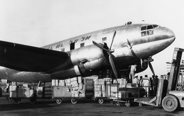 An EL AL C-46 in the freighter role at Lod Airport. EL AL recognized early the future potential of air cargo and started all-freight service with two of the capacious C-46s on 26 January 1950. (EL AL Archive)