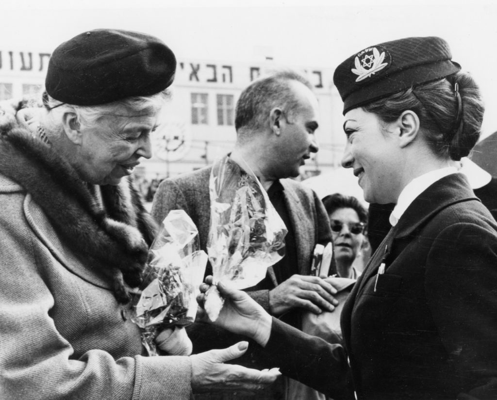 Eleanor Roosevelt, one of the many well-known international visitors carried by EL AL, is greeted by an airline hostess upon arrival at Lod Airport via an EL AL Britannia. On this trip she came to Israel to speak at a ceremony for the naming of the Eleanor Roosevelt Youth Center in Beersheva, 25 March 1959. (EL AL Archive)