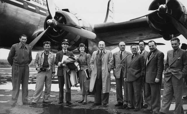 Arrival of EL AL's first aircraft, DC-4 4X-ACC, at Lod Airport, 3 April 1949. Left to right: Kopek Rosenberg, founder of Kopek Tours; unidentified; Maurice Kouffman, a former Mahal member and EL AL's first pilot; Marliyn Kouffman, his wife, who served as a stewardess on the flight; Uri Michaeli, head of civil aviation in the Ministry of Transport; Aryeh Pincus, first president of EL AL; Avraham Ryvkind, first head of commercial operations of EL AL; and Immanuel Tzur, head of Lod Airport. (Ozzie Goldman Photo)