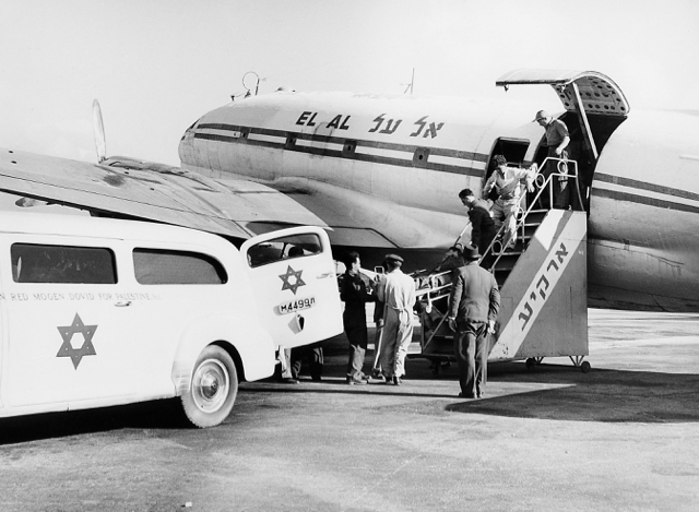 An ambulance flight between Eilat and Tel Aviv in April 1951. The EL AL C-46 has a plain color scheme due to the common repainting into non-Israeli liveries to allow refugee flights to land in other countries. The stairs say ‘Arkia’ in Hebrew; the ambulance still says ‘Palestine’, a leftover from the British Mandate pre-Israel days before May 1948. (Israel Government Press Office) 