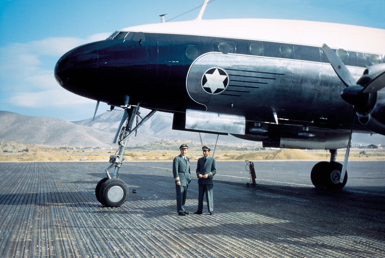 The dramatic royal blue and silver paint scheme of one of EL AL's first Constellations. Capt Sam Lewis (left), a hero in air transport during Israel's War of Independence and later chief pilot of EL AL for many years, is with Pete Rivas, flight engineer. Lewis was with EL AL 22 years, logging 28,000 flying hours. Following mandatory retirement at age 60, he started yet another flying career, becoming the chief instructor of Boeing 707 crews for Ecuatoriana and later the personal pilot for a luxuriously fitted 707 owned by a wealthy Israeli industrialist. (MG collection via Capt Sam Lewis) 