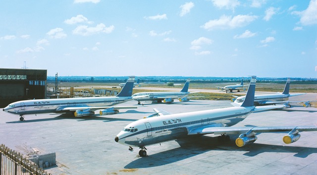 EL AL’s 707s and 720Bs grounded during a strike in the late 1960s. The aircraft are in the second of three successive EL AL 707/720B color schemes. This second livery is characterized by the ‘A’ of ‘EL AL’ having a sloped left side and straight right size (as in the EL AL block logo), and it served generally from 1964 to 1971. During that period the total number of aircraft in EL AL’s all-Boeing fleet ranged from five in 1964 to six in 1966 to ten in 1970-71. The 707s are longer than the 720s and have two emergency exit doors over each wing instead of one. (EL AL) 
